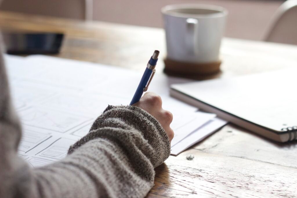Student revising past papers for GCSE exam preparation